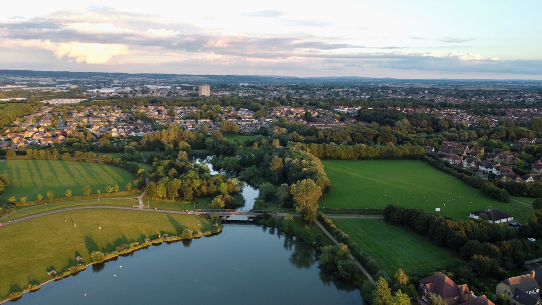 Milton Keynes, Buckinghamshire: aerial view of green grass field near lake during daytime